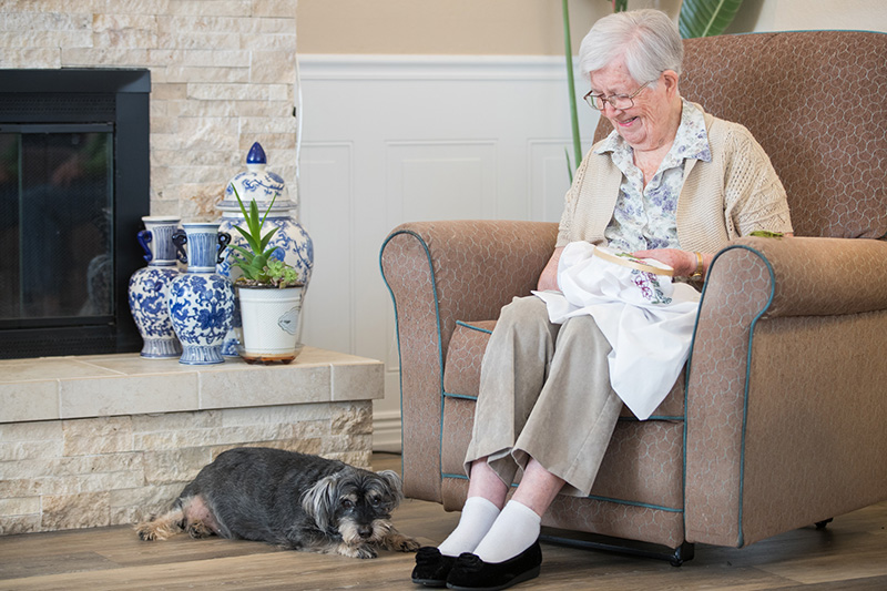 elderly woman knitting in the living room at a senior facility in Modesto