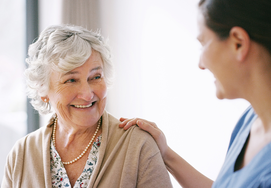 An empathetic caregiver offering support and comfort to an elderly lady in the compassionate and secure environment of an Modesto assisted living facility. This image captures the essence of personalized care and the strong sense of companionship that defines the facility's commitment to the well-being of its residents.