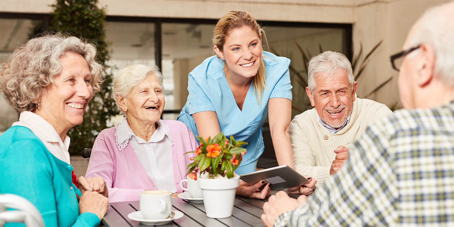 A group of joyful seniors sharing laughter and camaraderie while gathered around a table at an assisted living in Modesto