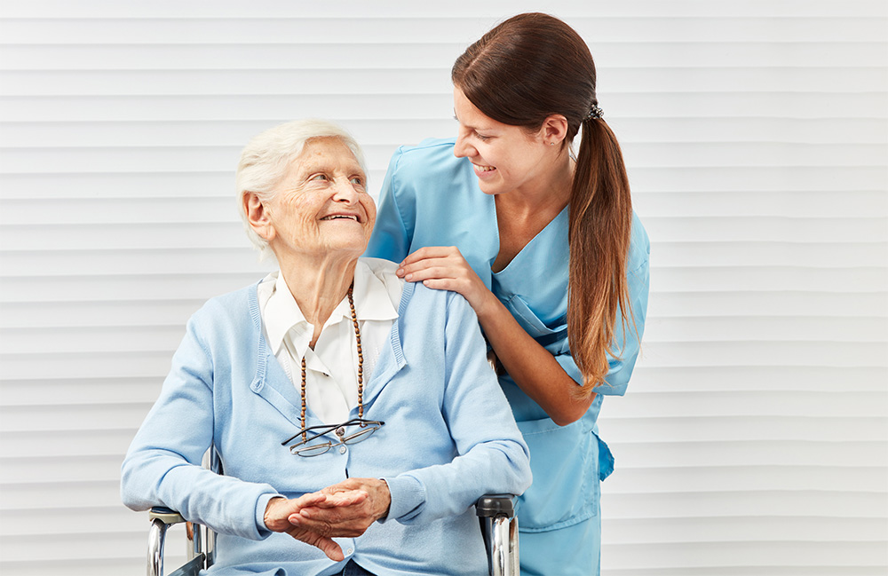 caregiver and elderly lady looking at each other