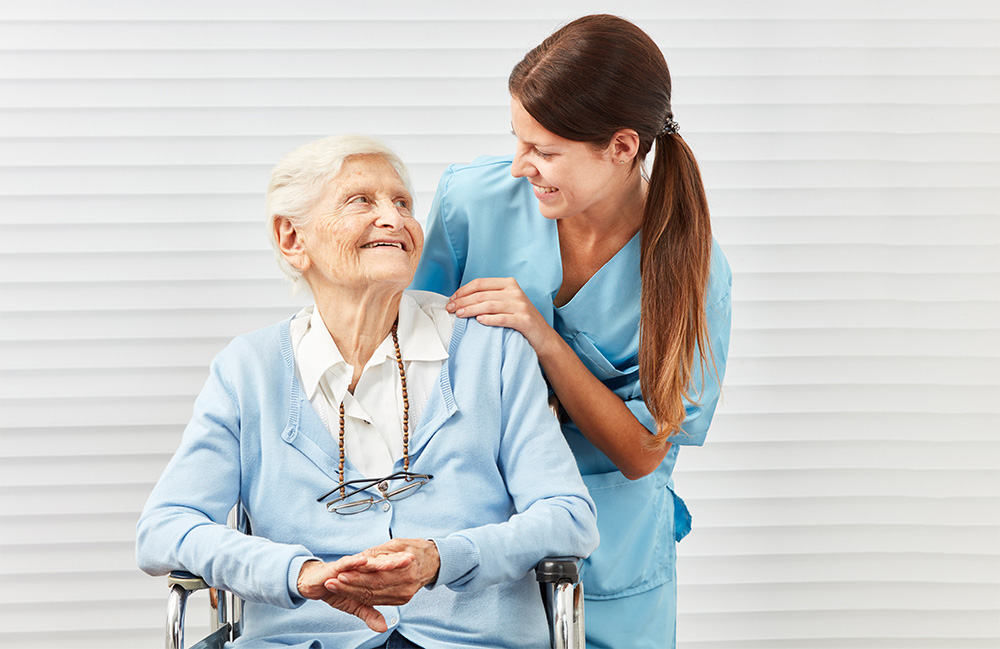 caregiver and elderly lady looking at each other with love