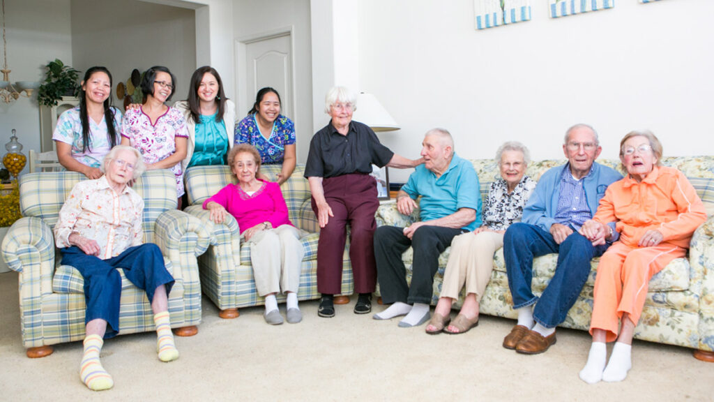 a group photo of residents at Graceful Living, all happy and smiling for the camera