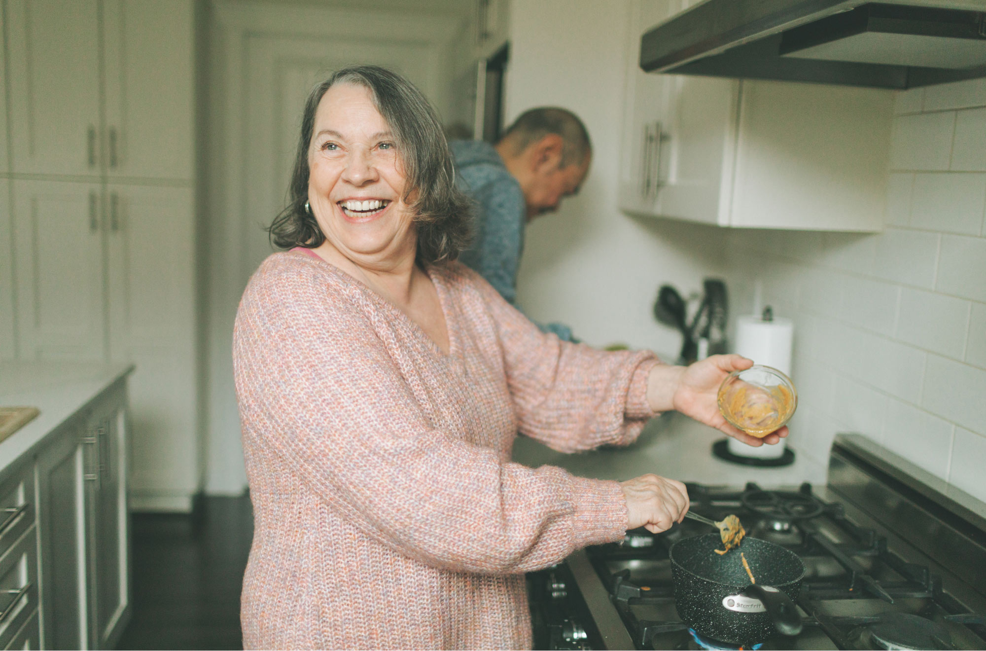 senior woman laughing in the kitchen